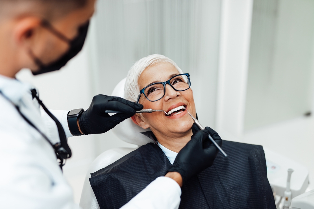 Dentist explaining dry socket prevention to a patient in a dental office